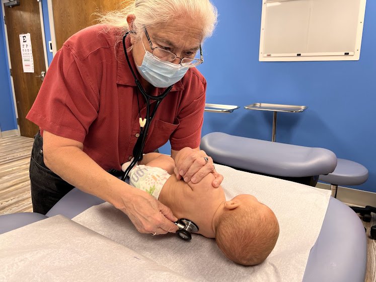 Dr. Tess Garcia caring for an infant